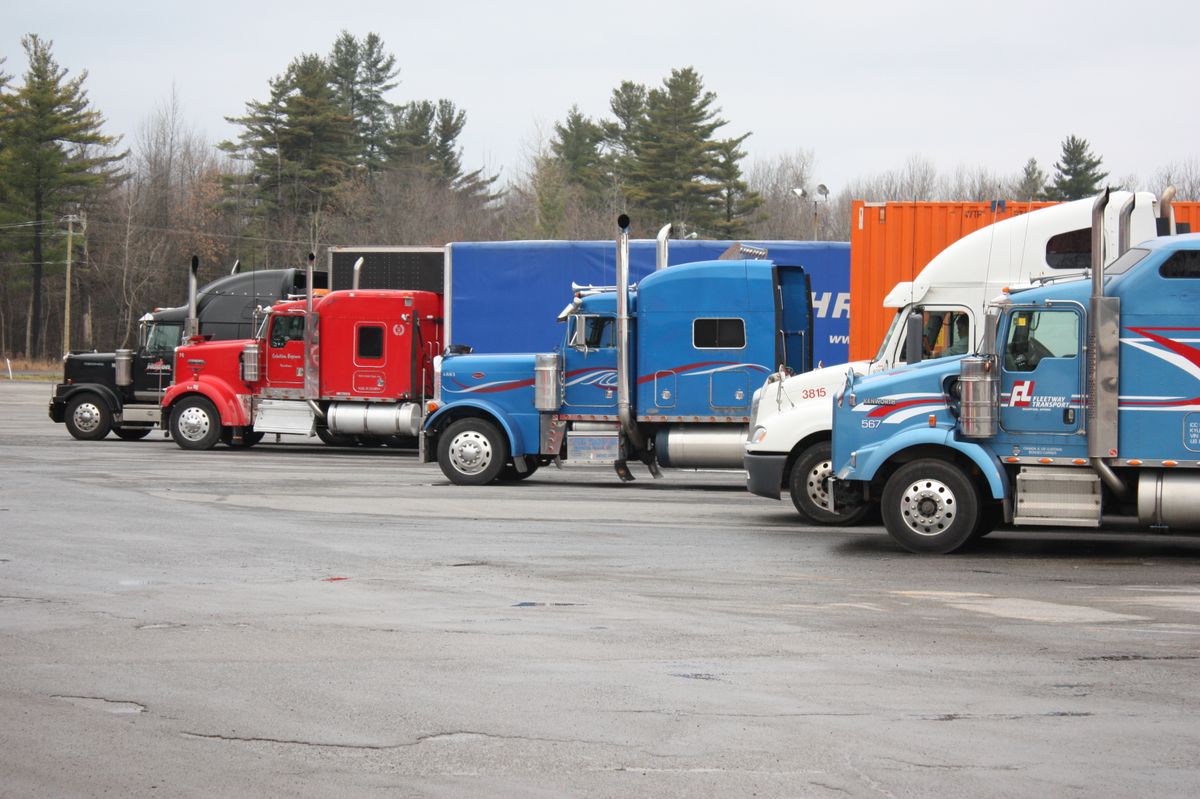 Semi trucks parked in a truck lot